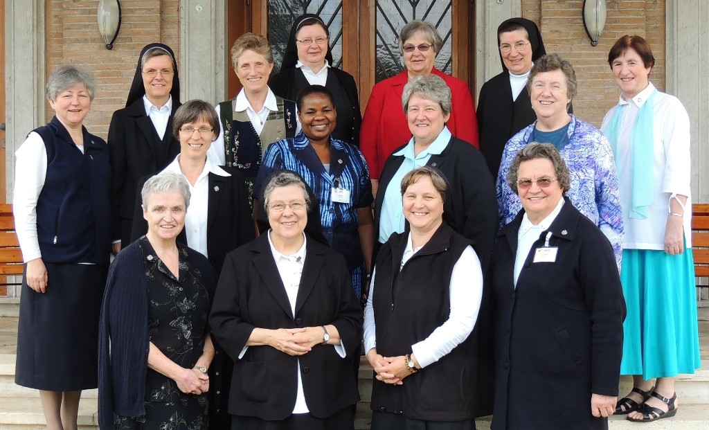 The members of the 11th Extended General Council: Front row: Sister Maureen McGoey, Schwester M. Beatrix Mayrhofer (ÖR-IT, includes CE), Sestra M. Magda Burger (SI), Irmã Cecilia Martinello (ALC) Middle row: Lobmayer M. Judit növér (MG), Sister Joyce Nyakwama (AF), Sister Mary Maher, Sister Mary Anne Owens (CP) Back row: Irmã Inês Camiran, Schwester M. Charlotte Oerthel (BY), Sister Carol Jean Dust, Schwester M. Dominica Michalke, Sister Kathleen Cornell (AM), Siostra M. Irenea Książak (PO), Irmã Vitória Marques.